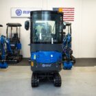 Front view of Rippa R15 Eco enclosed cab mini excavator with rubber tracks and dozer blade