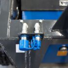 Close-up of Rippa RS04 skid steer hydraulic connections and reinforced steel frame